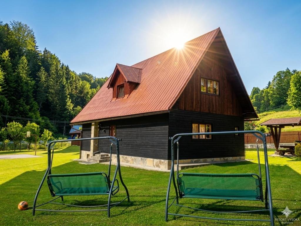 a house with a basketball hoop in front of it at Chata Sipkova I in Terchová