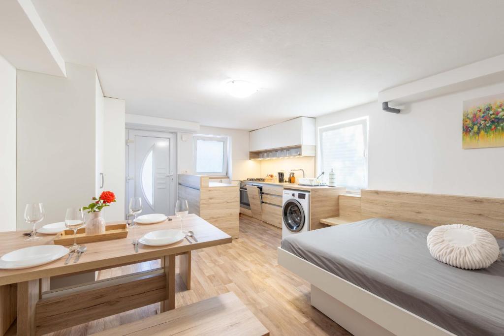 a large bedroom with a bed and a kitchen at Poli in Šmarje-Sap