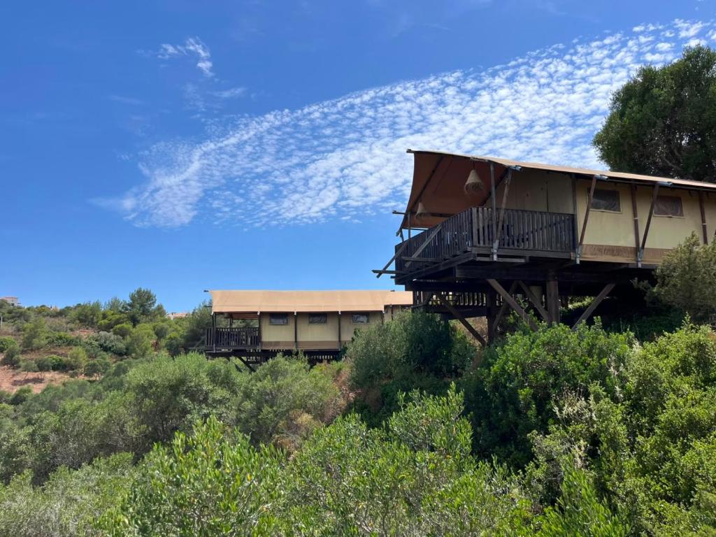a house sitting on top of a hill at Salema Eco Camp - Sustainable Camping & Glamping in Salema