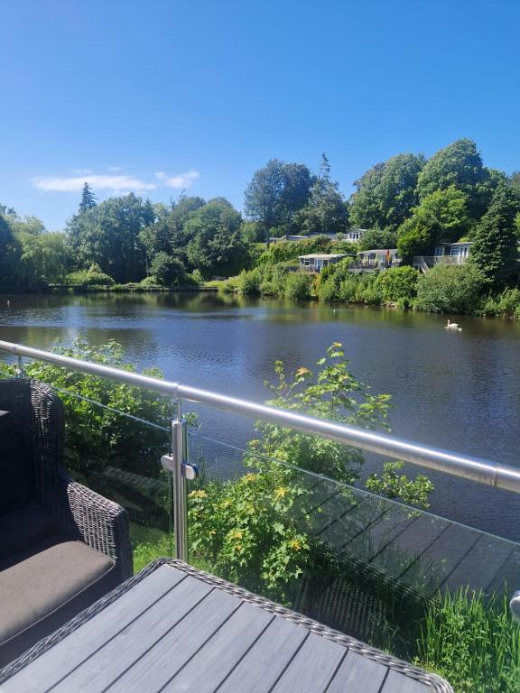 a balcony with a view of a river at Chalet 85 in Caeathro