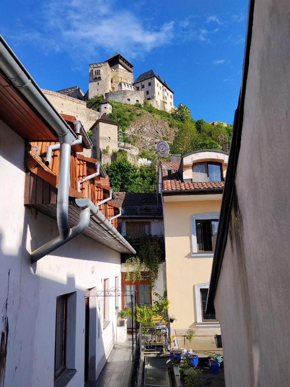 a town with a castle on top of a hill at Apartmán pod hradom B in Trenčín