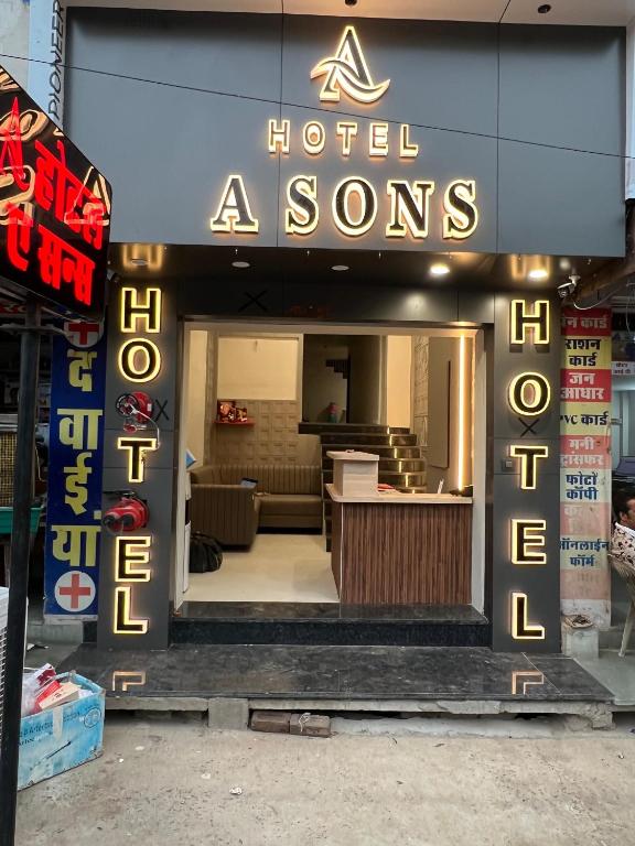 a hotel entrance with a sign that reads hotel aoms at hotel a sons in Chittaurgarh