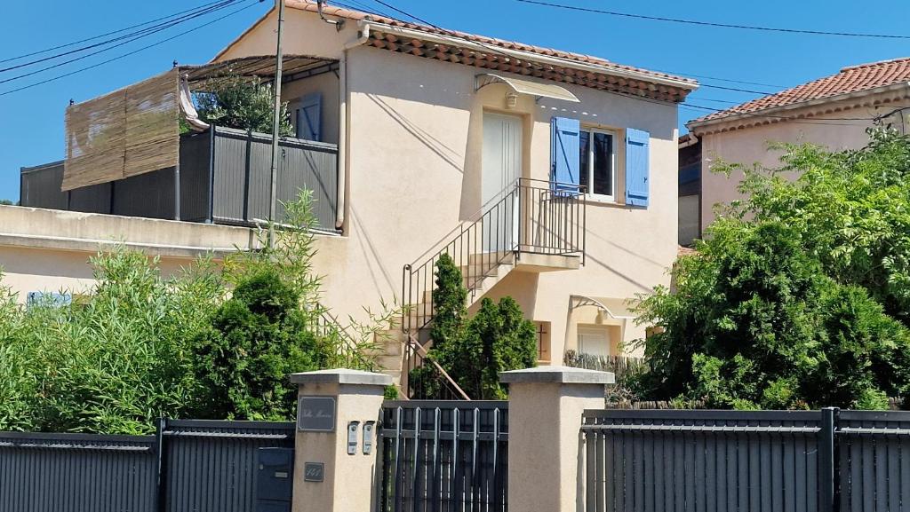 a house with a fence in front of it at Studio Villa Monica in Vallauris