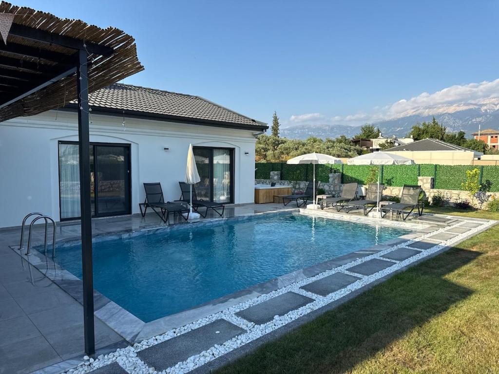 a swimming pool in the backyard of a house at Private Pool Villa with Jacuzzi & Garden in Girdev