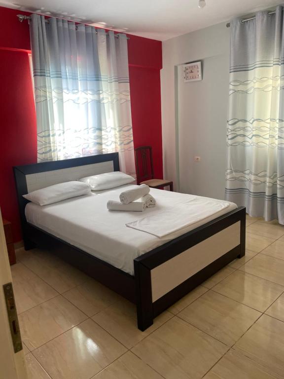 a bedroom with a bed with a phone on it at Aparthotel Borsh in Borsh