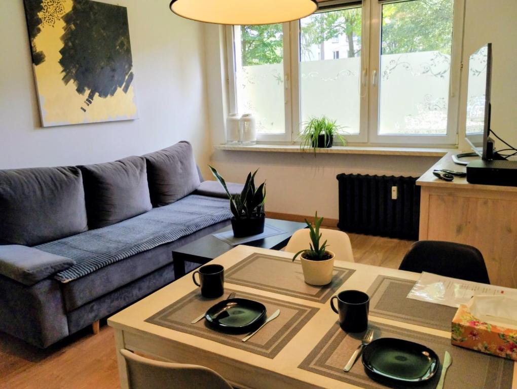 a living room with a couch and a table at Studio park Katowice/Chorzów in Chorzów