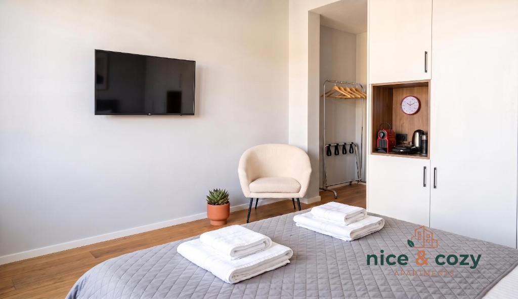 a room with a bed with two towels on it at Nice and Cozy Apartments in Néa Khilí