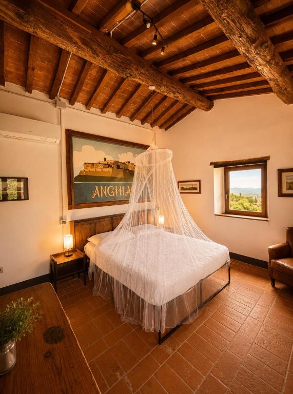 a bedroom with a bed with a mosquito net at Il cielo di Anghiari Guest house in Anghiari