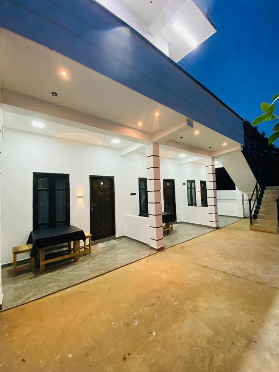 an empty living room with a blue ceiling at NRT Beach Hotel in Trincomalee