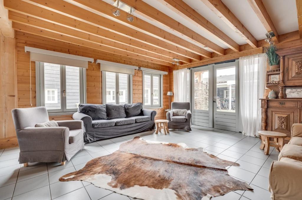 a living room with wooden walls and a wooden ceiling at Green House in Koudekerke