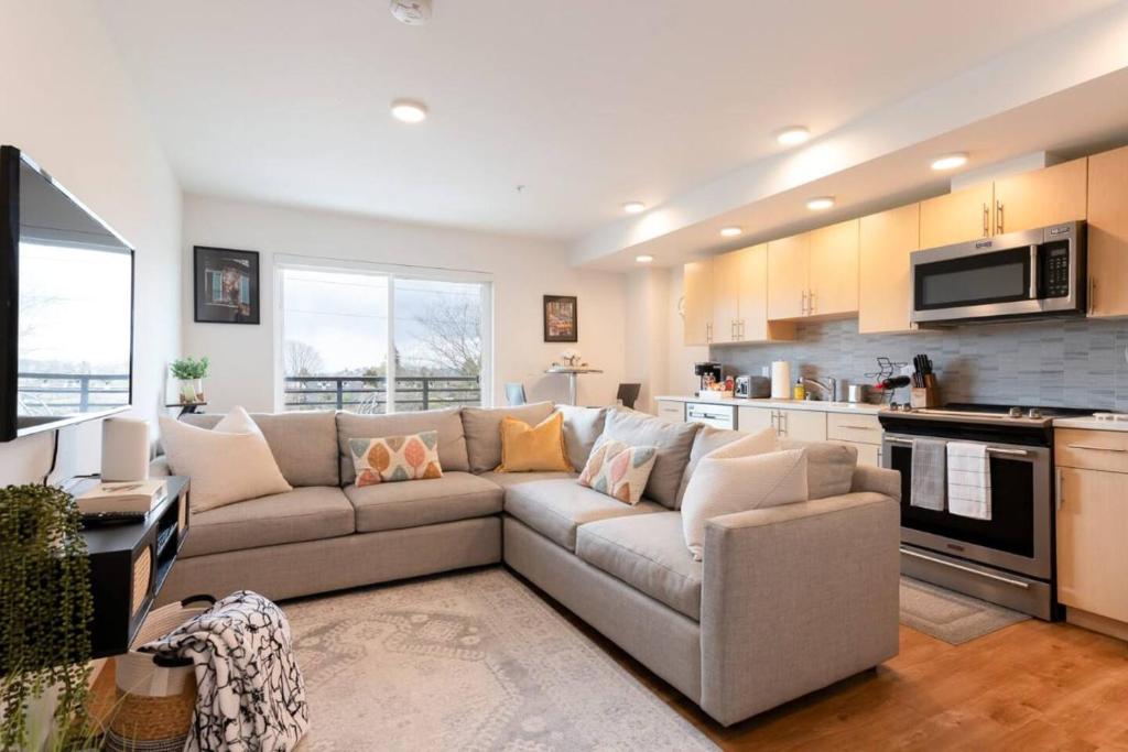 a living room with a couch and a kitchen at Stunning Capitol Hill 1BD Condo in Seattle