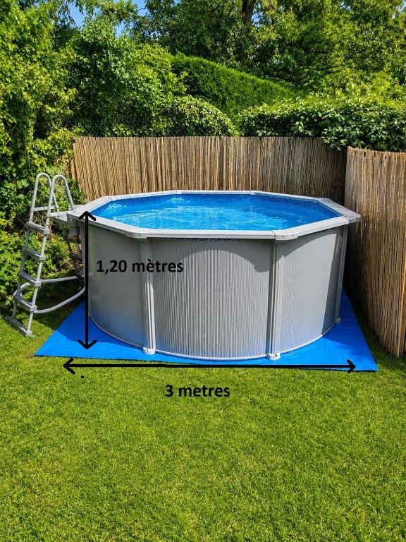 a small pool in a yard with a fence at Echappée verte avec piscine et clim proche de Paris in Vert-le-Grand