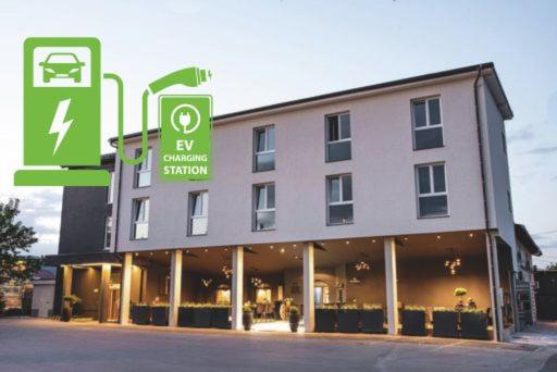 a large building with a sign in front of it at Hotel Leonardo in Slovenska Bistrica