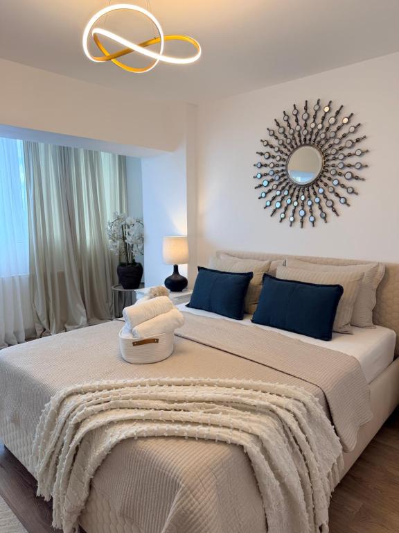 a bedroom with a large bed with a mirror on the wall at Urban Central Hub in Giurgiu