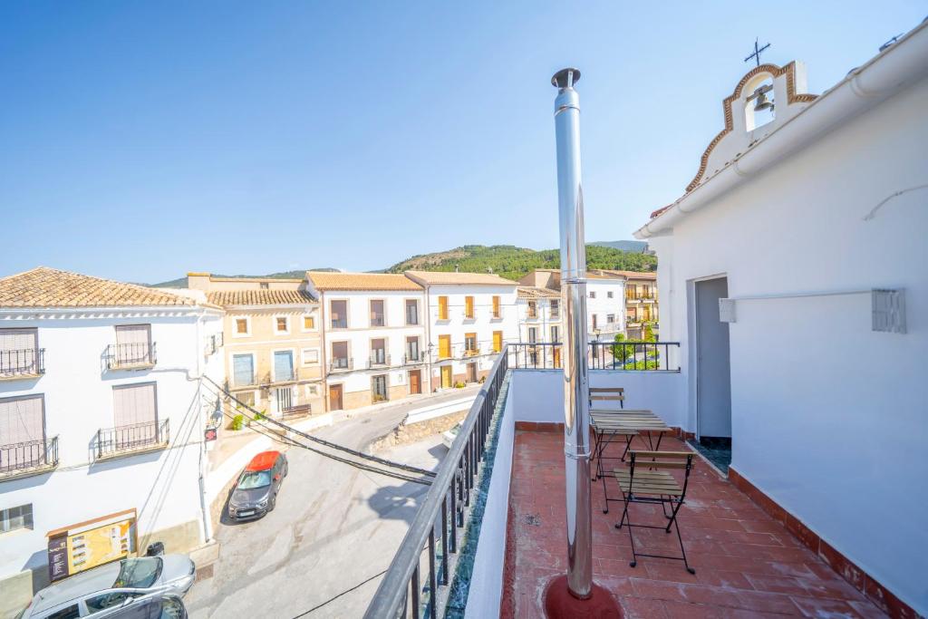 a balcony with chairs and a view of a city at Casa El Pilar in Serón