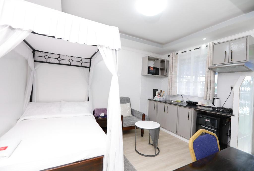 a bedroom with a bunk bed and a kitchen at Studio Guest Suite in Nakuru