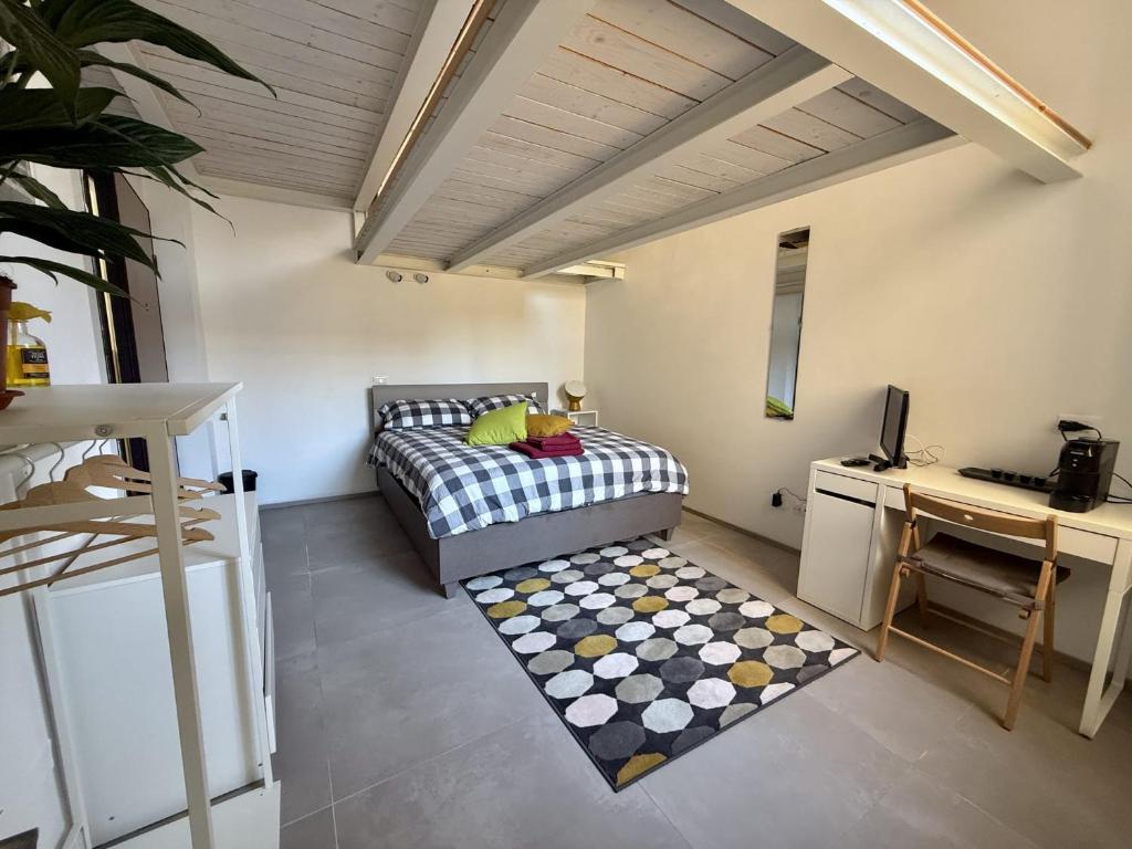 a bedroom with a bed and a table and a rug at Guglie's Guest House in Livorno