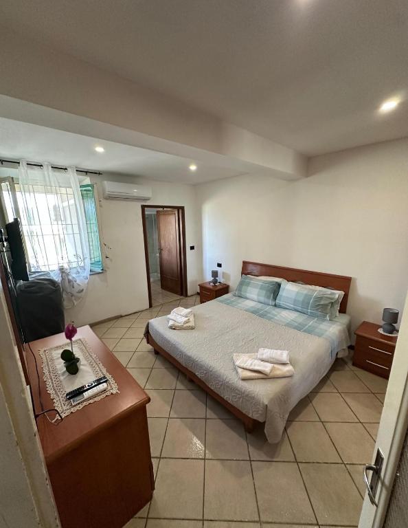 a bedroom with a bed with two towels on it at NidoPorcari in Porcari