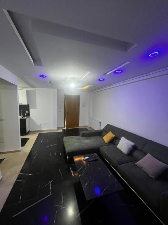 a living room with a couch and purple lights at Sweet home in Ariana