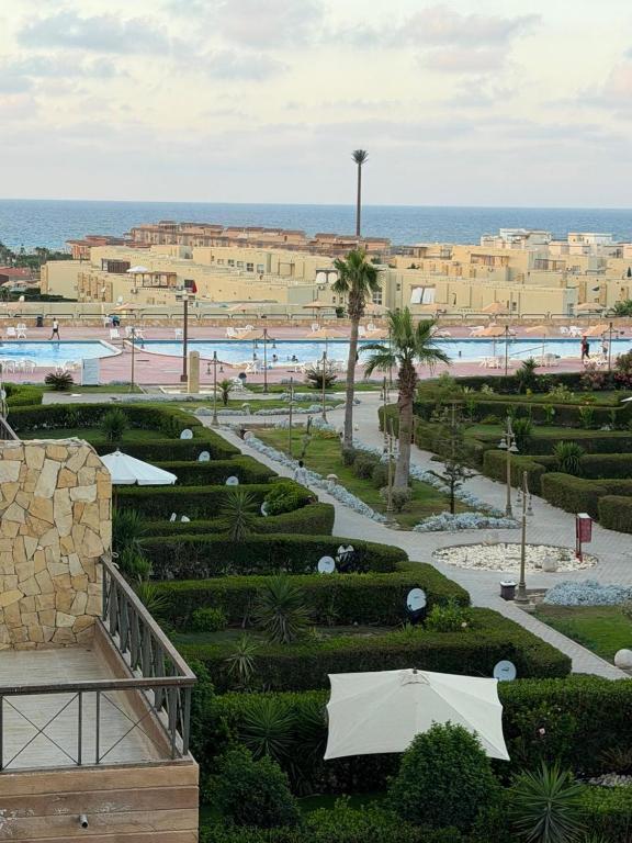 a view of a resort with a pool and the ocean at Studio 3rd Floor Blumar one bedroom in El Alamein