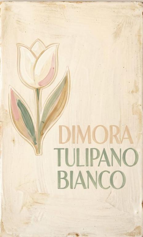 a sign for a drug store with a flower at Dimora IL TULIPANO BIANCO in Massafra