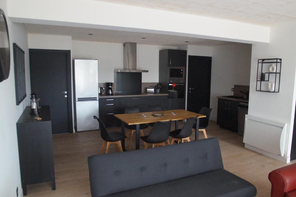 a kitchen and dining room with a table and chairs at Ty Le Gall in Plouescat