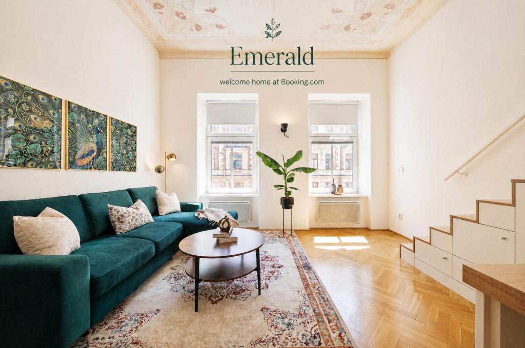 a living room with a green couch and a table at Gem Stone City Center in Olomouc