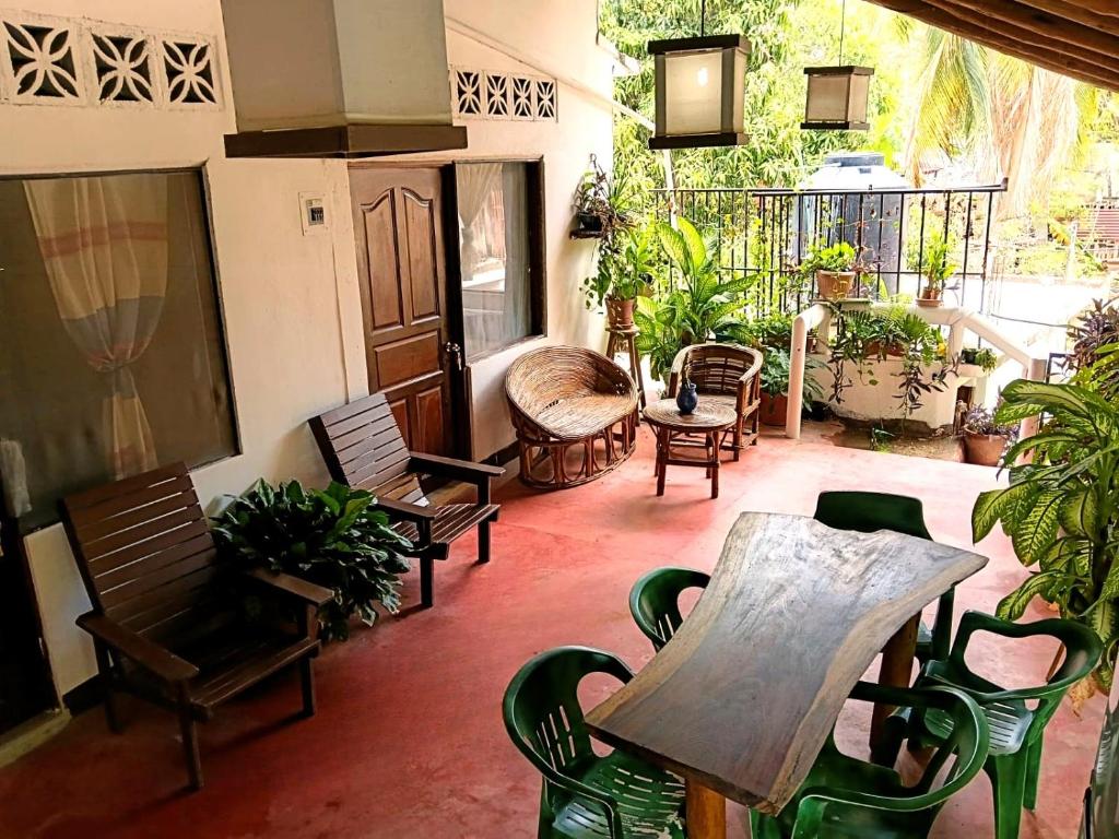 a patio with chairs and a wooden table on a patio at Casa Tania in Mazunte