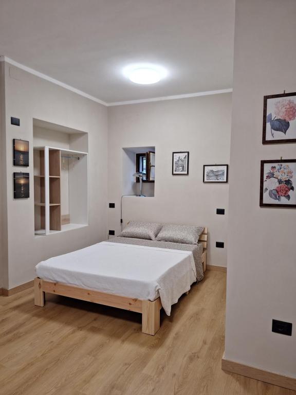 a bedroom with a bed in a white room at La Giara in Spoleto