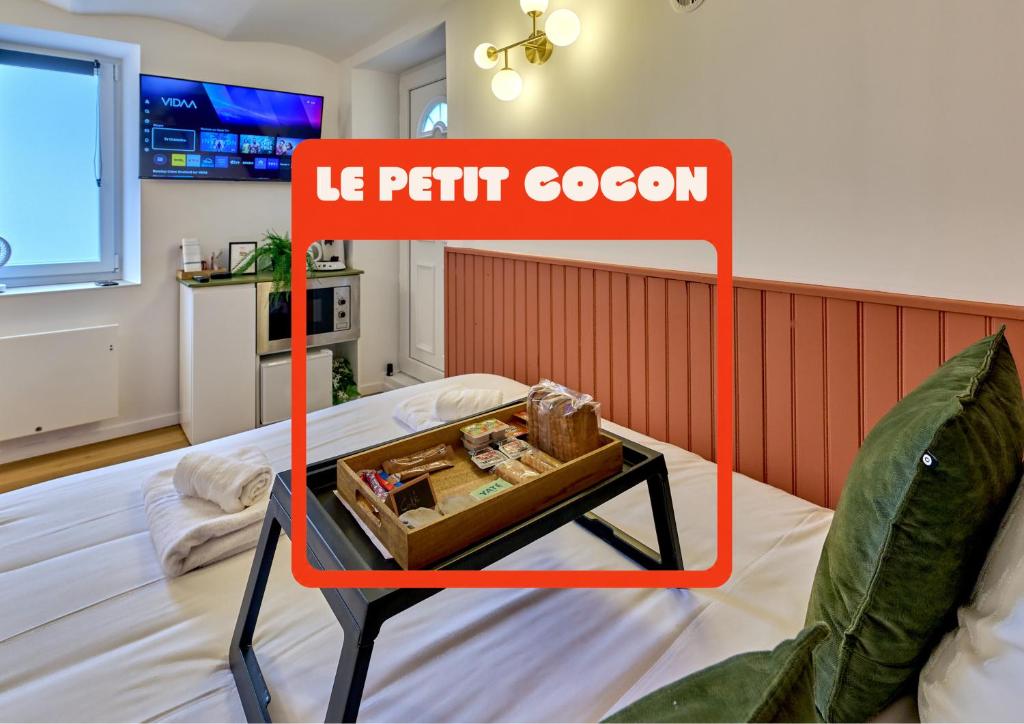 a table on a bed in a room at Le Petit Cocon, Hotel Style Ideal for Professionals or Couples in Nevers