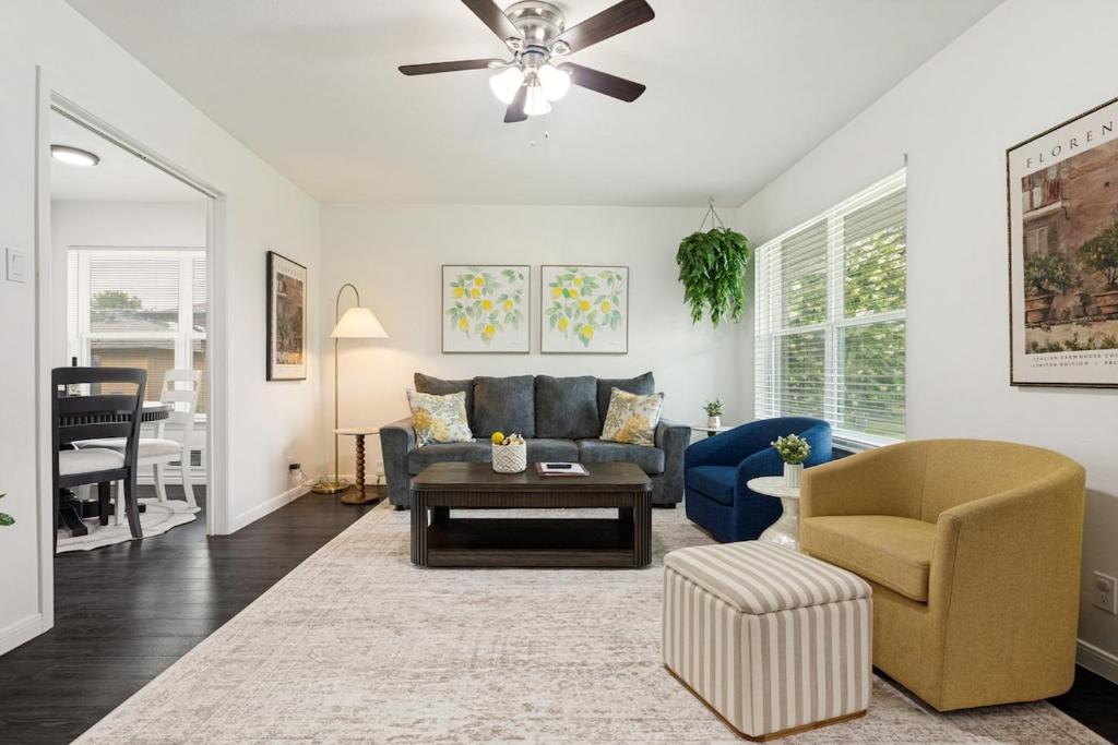 a living room with a blue couch and a chair at Italian Cottage 2B 1B Duplex KING Pet Friendly in Richardson