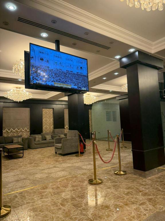 a lobby with a large screen on the ceiling at غرفه سويت مع مطبخ in Buraydah