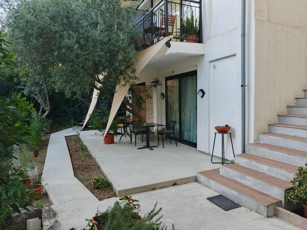 an external view of a house with a patio at Apartments Spasoje 2 in Kotor