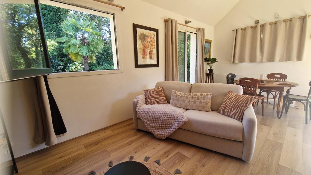 a living room with a couch and a table at Ty ar C'hoad in Sulniac