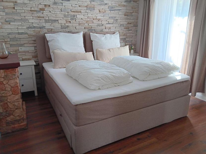 a bed with two pillows on it in a room at Ferienwohnung unterm Kirschbaum in Großenlüder