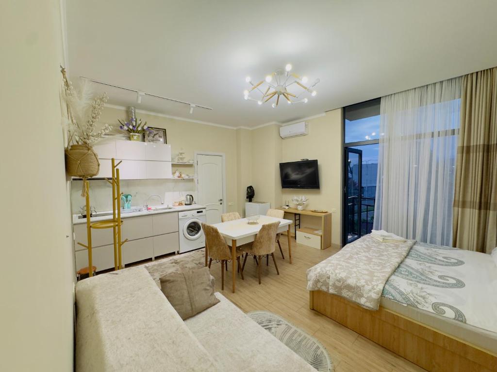 a bedroom with a bed and a dining room at Rusa in P'eria