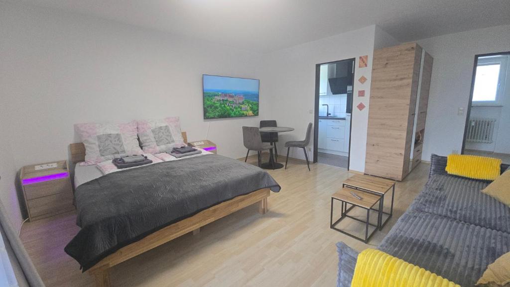 a bedroom with a bed and a table with chairs at InnJoy! in Friedrichshafen