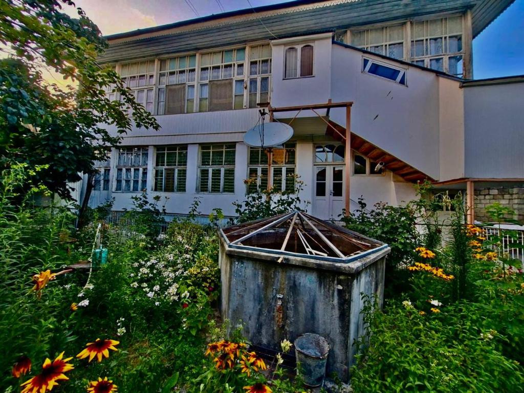 a house with a garden in front of it at myGrandma's home in Sheki