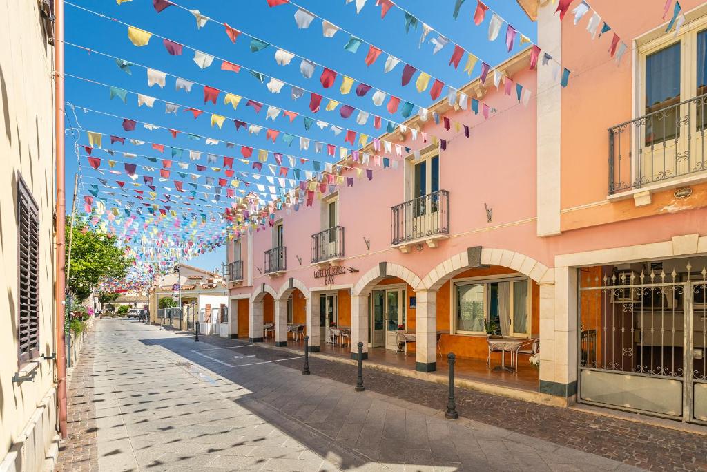 a street in a town with a string of flags at Hotel Del Corso in Pula