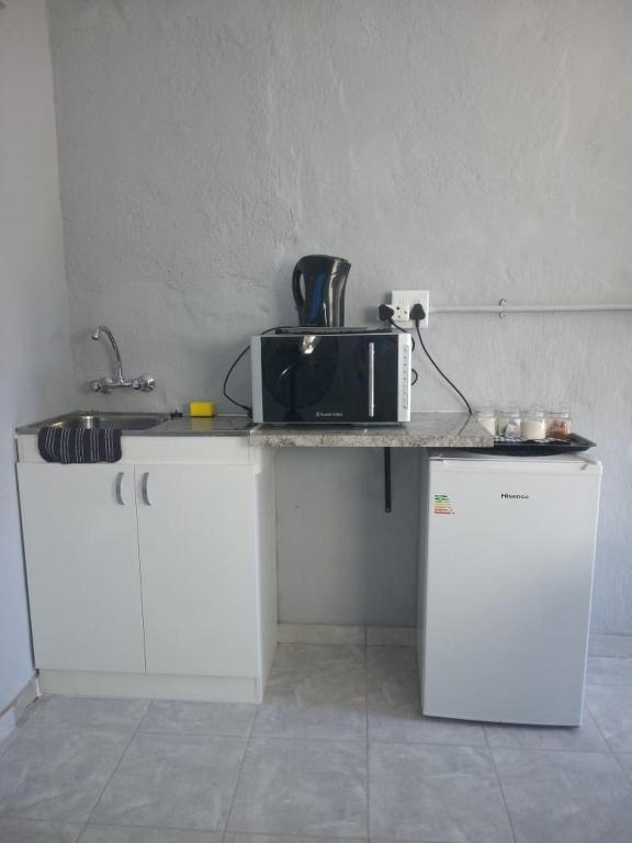 a kitchen with a counter with a microwave on it at JJM Accommodation in Keetmanshoop