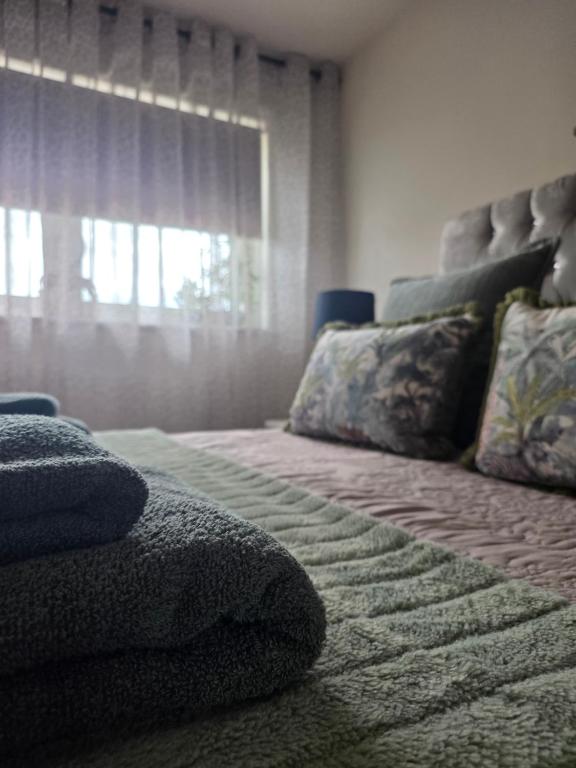 a bedroom with a large bed and a window at Hampton Water Rooms Peterborough in Peterborough