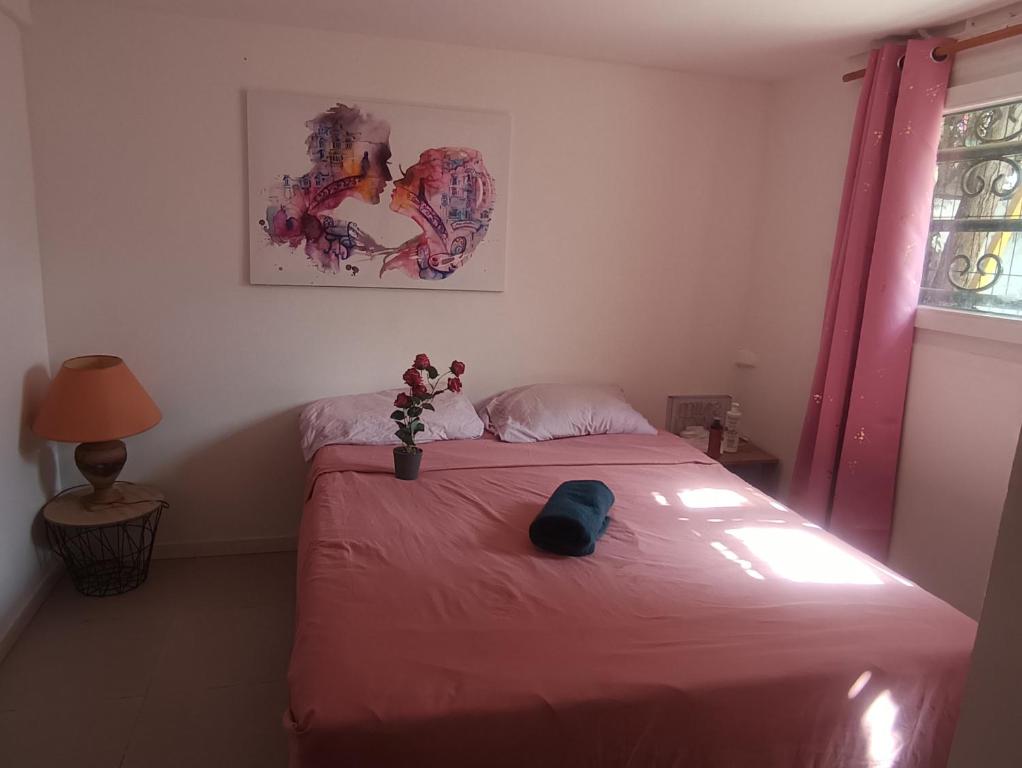a bedroom with a bed with a red blanket at Maison du Bonheur Chelles in Chelles