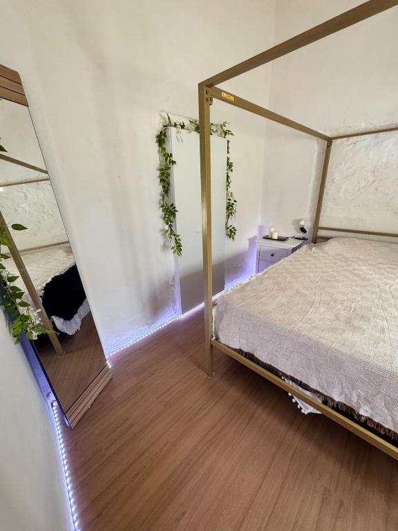a bedroom with a canopy bed and a mirror at Love Home Ronquillo in El Ronquillo