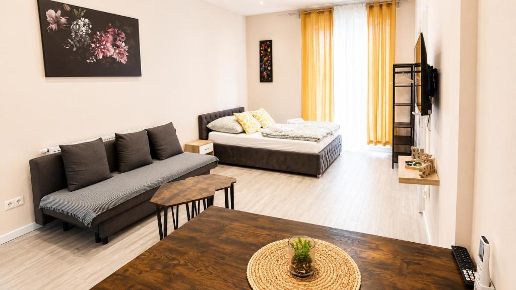a living room with a couch and a table at Subway Apartment in Koblenz