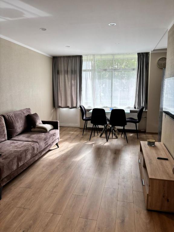 a living room with a couch and a table at Miera osta in Salacgrīva