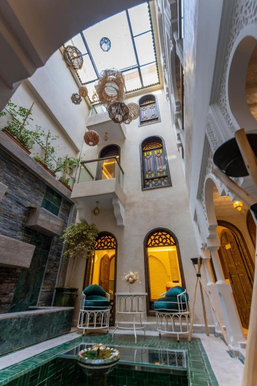 a house with a pool in the middle of a building at Riad Secret Mahjouba in Marrakesh