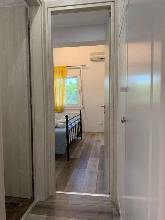 a hallway with a door leading to a bedroom at Lemon Tree Apartment in Chios