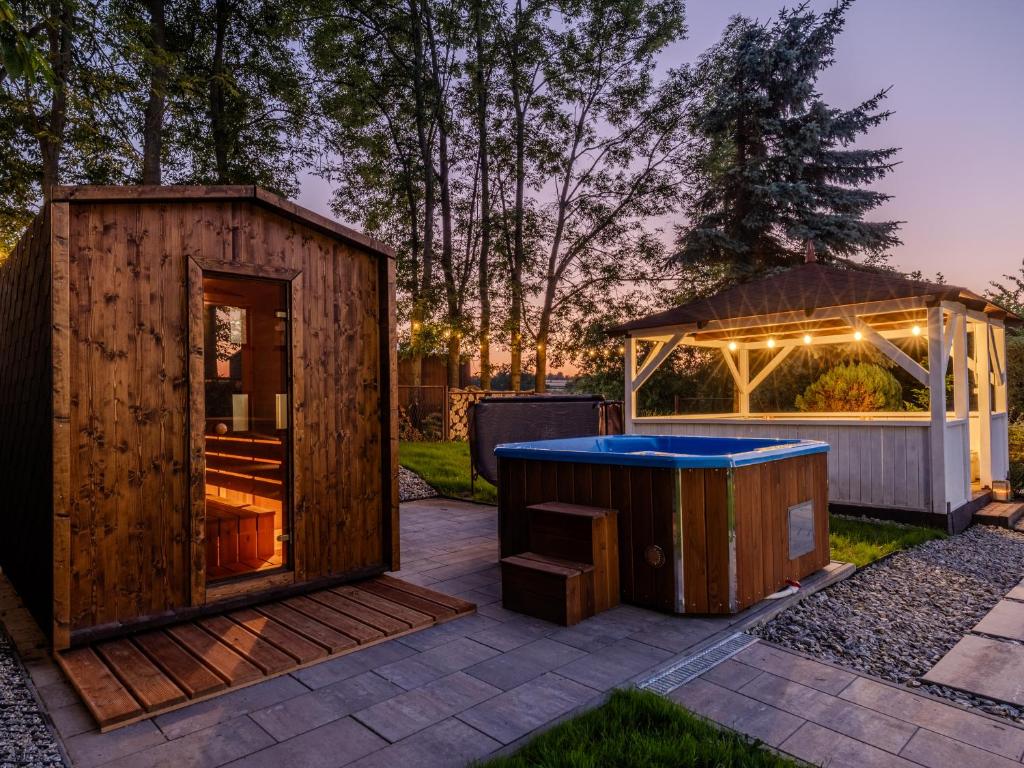 a wooden building with a hot tub and a gazebo at OSNOWA Racławice in Racławice