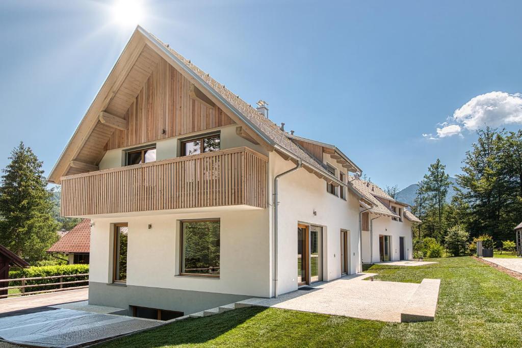 a house with a wooden roof at Bohinj Rentals Twin Villas in Bohinj