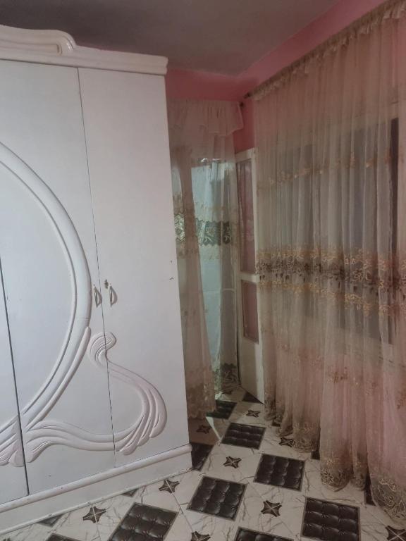 a bathroom with a shower and a white cabinet at Sobh safa holiday in Al Ghuşnah
